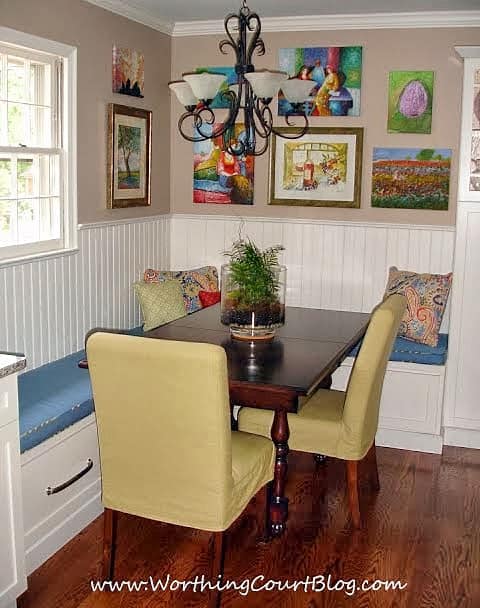 Original artwork collected over time fills the breakfast nook nicely in this remodeled kitchen