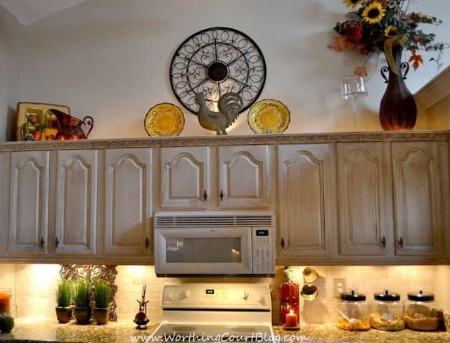 DIY French Country Kitchen Makeover: Rope lighting added above the cabinets by drilling through the top of the cabinets to access the electric outlet for the microwave