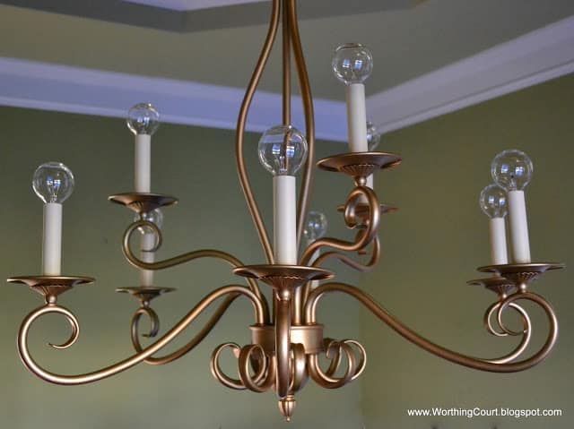 Worthing Court; update an old bronze chandelier with gold spray paint and modern shaped light bulbs