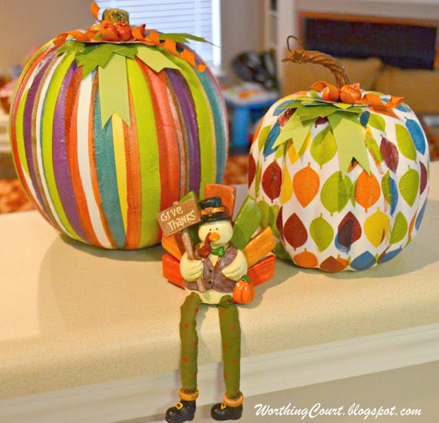 Completed faux pumpkins that have decorative napkin strips applied with ModPodge