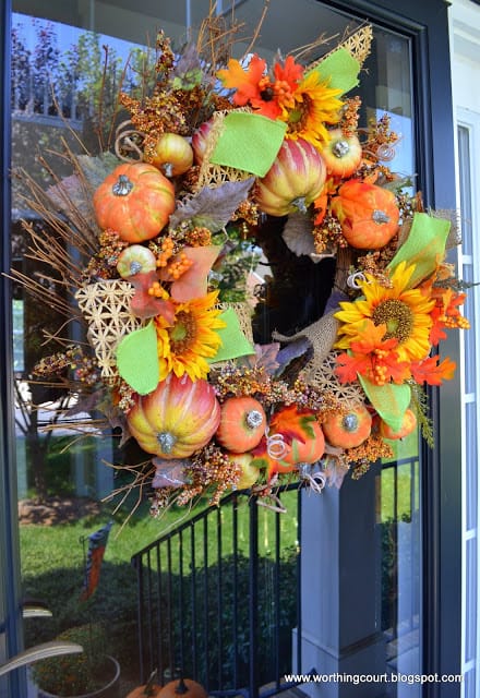 Pumpkin wreath with bits of raffia ribbon and burlap ribbon added