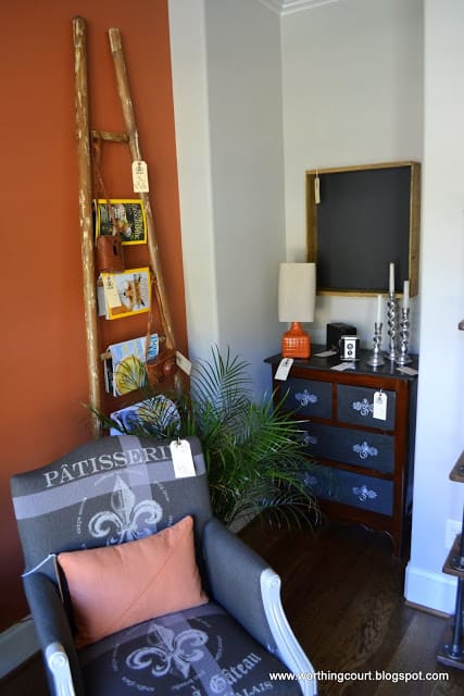 ladder used as a magazine rack in this gray and burnt orange office via Worthing Court blog
