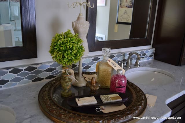bathroom vignette on a round mirror via Worthing Court blog