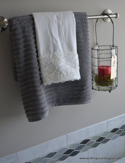 candle and lacy towel hanging from a towel bar via Worthing Court blog