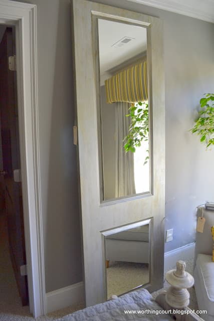 mirrors attached to vintage door leaned against the wall via Worthing Court blog
