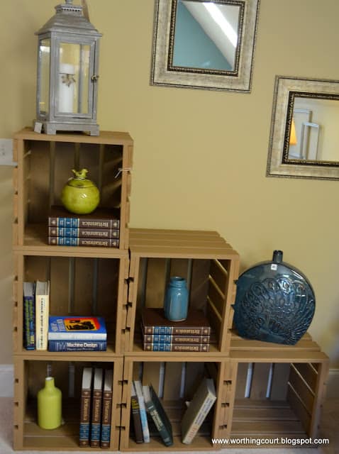 Stacked wooden crates create a bookshelf via Worthing Court blog
