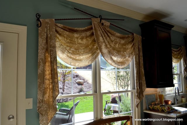 swag and jabot window treatment with iron hardware via Worthing Court blog