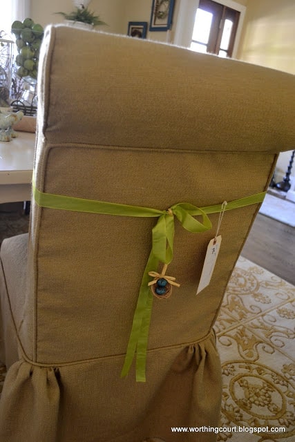dining room chair slipcovered in linen with a ribbon accent and birds nest embellishment via Worthing Court blog
