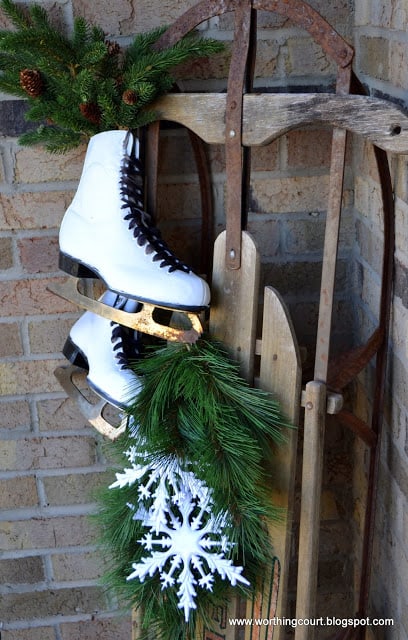 A front porch is a great place to display a vintage sled as part of winter decor