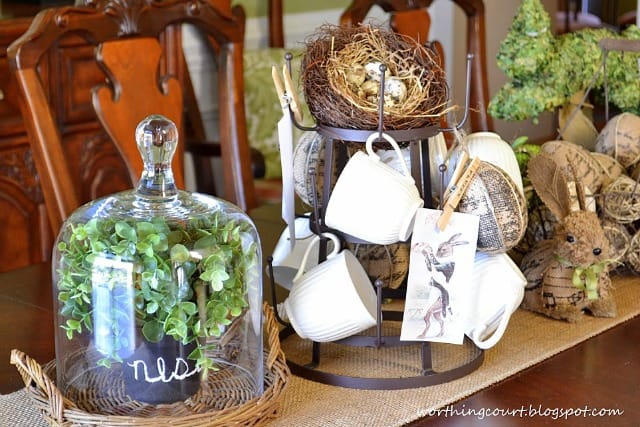 To use a mug tree in an Easter centerpiece I topped it with a bird nest, hung a few white mugs and burlap eggs on it. I printed vintage Easter cards on regular paper and clipped them to the mug tree with clothes pins that were stamped with Easter'ish words.