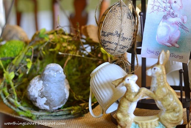A chippy bird and faux bird nest are part of an Easter centerpiece