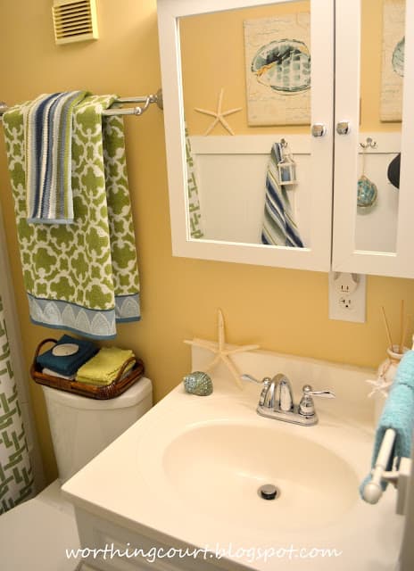 A small white sink with a starfish on it.