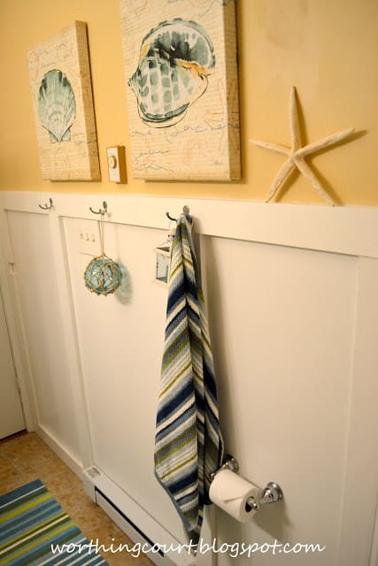 There is a starfish and towel on the wall.
