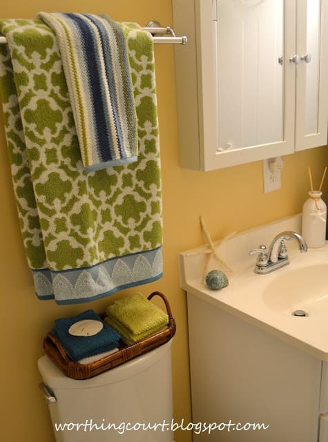 Green and blue and white towels in the bathroom.