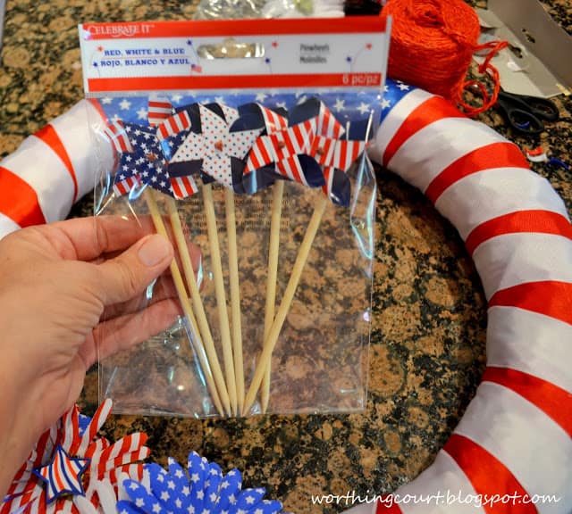 Gluing pinwheels onto the wreath.