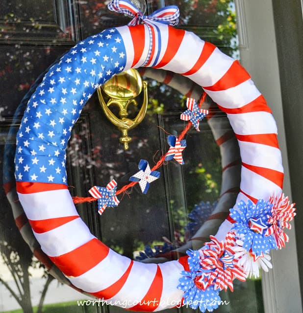 Patriotic Wreath in red, white and blue hanging on the door.