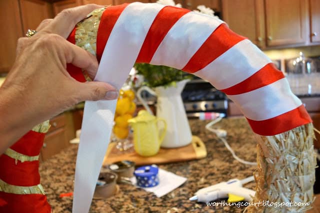 Wrapping white ribbon around the wreath.