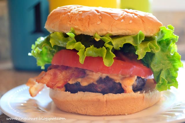 A burger on a white plate.