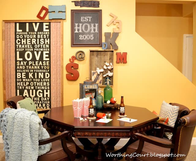 Typography Gallery Wall and Game Table in the decorated room.