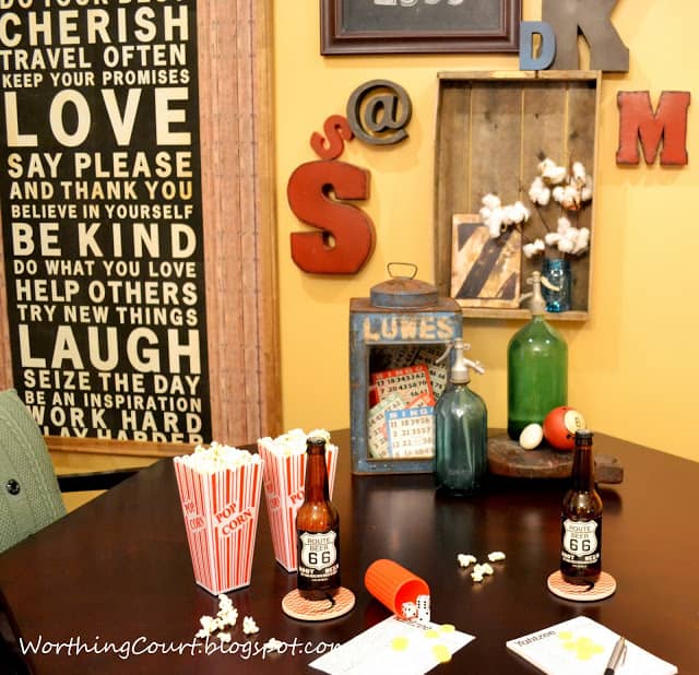 Letters on the wall, with a table filled with popcorn and beer.