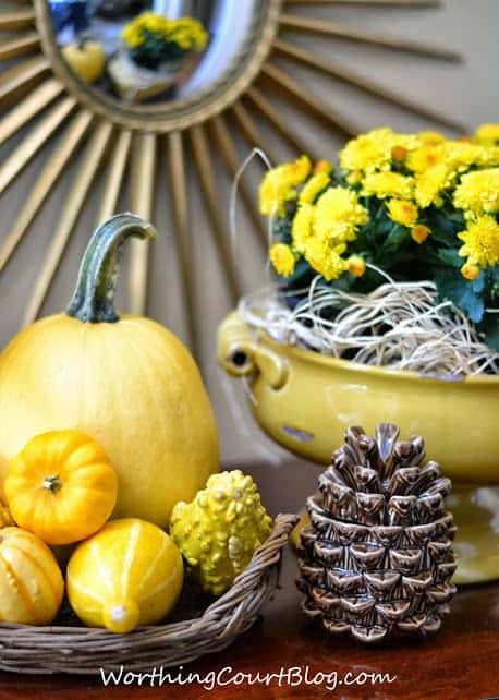 Worthing Court: fall foyer vignette with yellow pumpkins, gourds and mums