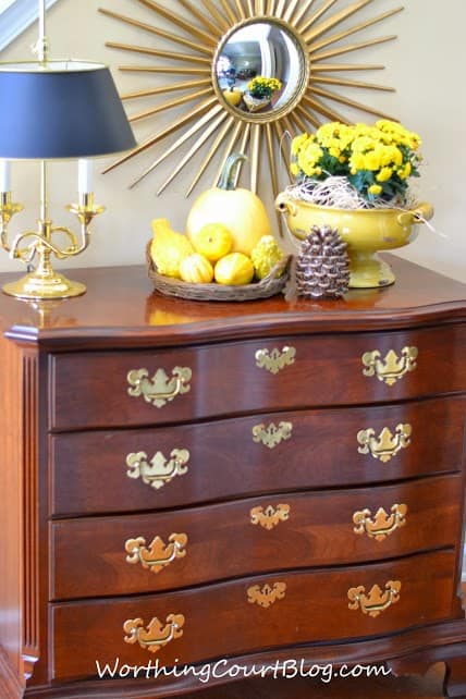 Worthing Court: fall foyer vignette with yellow pumpkins, gourds and mums