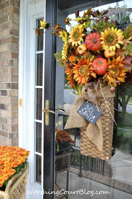 Worthing Court: Front door arrangement with fall florals embellished with burlap ribbon and a mini chalkboard