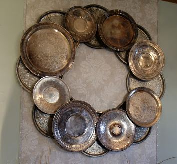 Vintage silver trays glued together to form a holiday unique wreath.