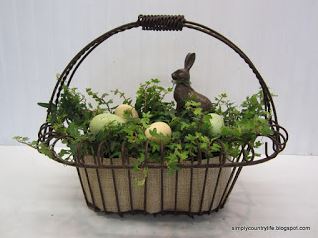 A bunny inside a wire basket.
