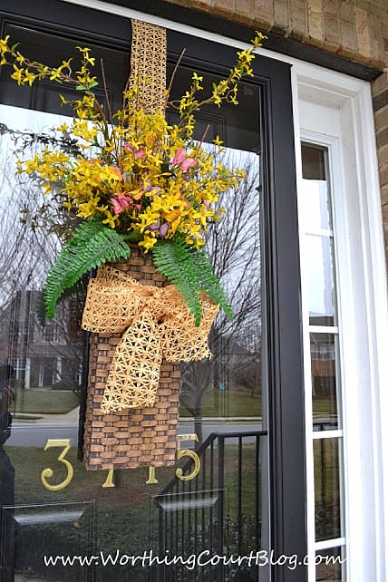 Nothing announces the arrival of spring more than when forsythia begins to bloom. Instead of a traditional wreath, fill a basket with faux forsythia stems and add a little something for color and greenery. Add ribbon to complete the welcoming arrangement. || Worthing Court Blog