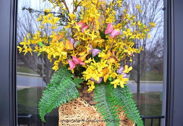 Nothing announces the arrival of spring more than when forsythia begins to bloom. Instead of a traditional wreath, fill a basket with faux forsythia stems and add a little something for color and greenery. Add ribbon to complete the welcoming arrangement. || Worthing Court Blog