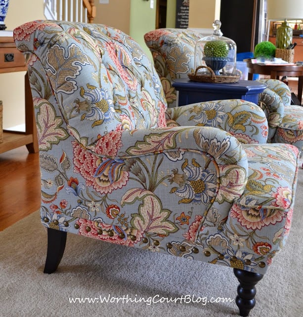 A floral armchair with shades of blue, pink and cream.