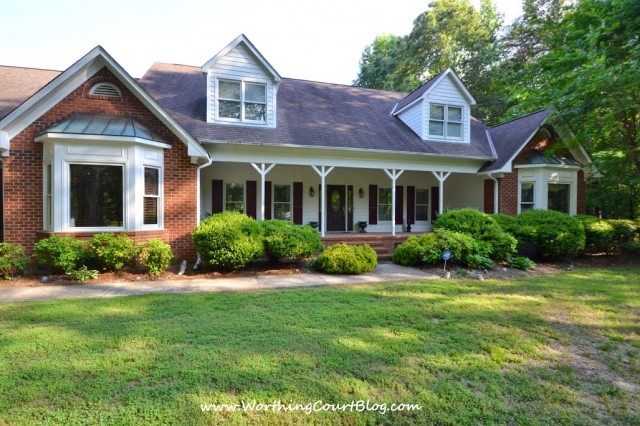 House with large front porch, two bay windows and dormers