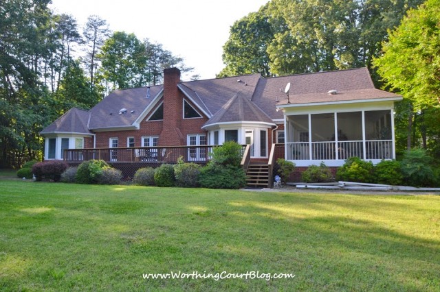 Back of house with screened porch and large deck