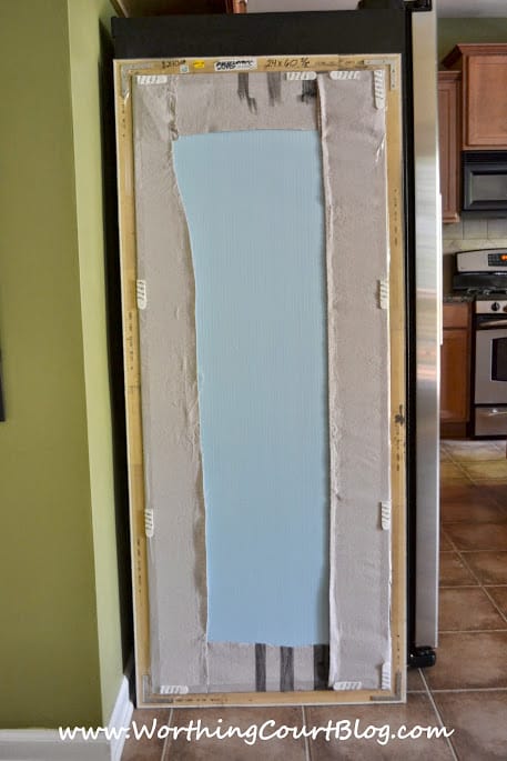 Backside of diy bulletin board that will be used to hide the side of a refrigerator