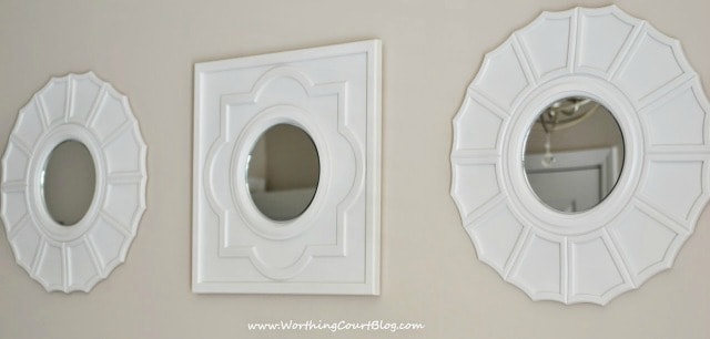 Mirrors made by spray painted ceiling medallions and hot-gluing a craft mirror to the center.