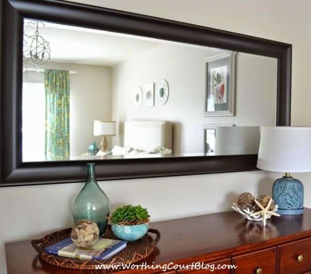 An oversized mirror visually enlarges a room