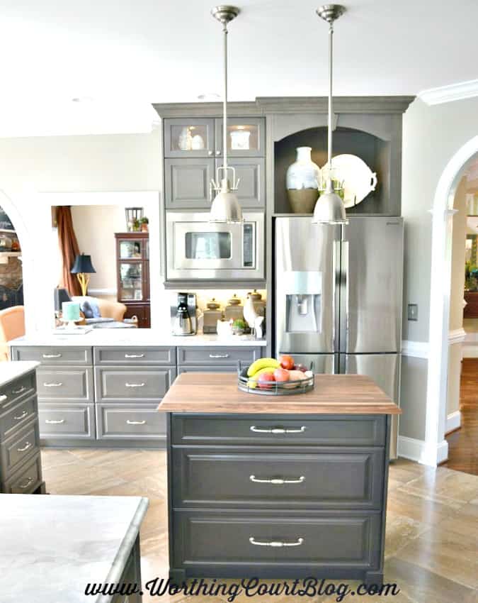 Remodeled kitchen with a built in microwave and display nook above the refrigerator.