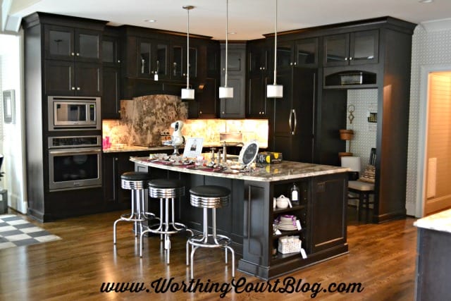 Kitchen with black cabinets decorated with mid-century modern details