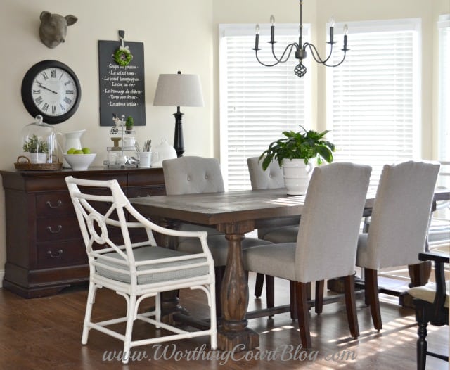 Farmhouse kitchen table, chairs and vignette. The dresser holds kitchen towels, aprons and table linens.