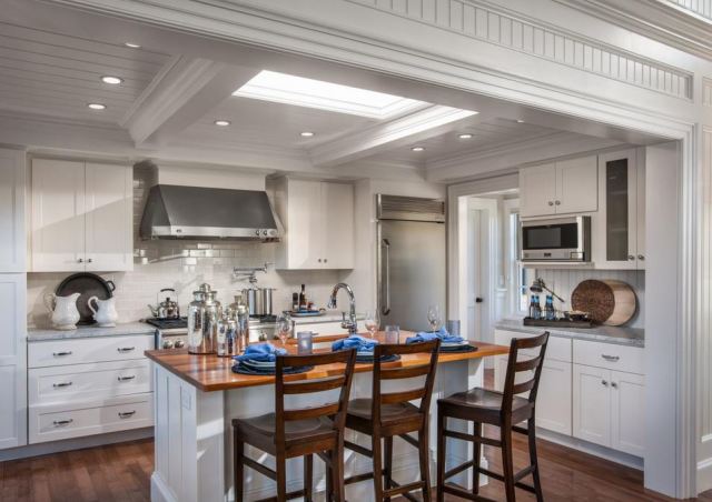 The addition of wood warms up an all white kitchen