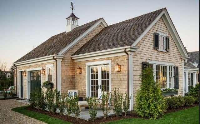 Add a cupola and pretty landscaping to an outbuilding, like a storage shed.