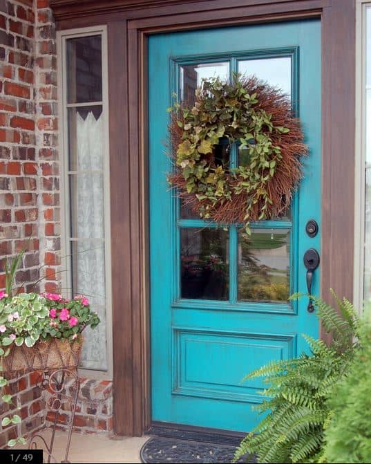 A bright antique blue door front colour with a wreath on the front door.