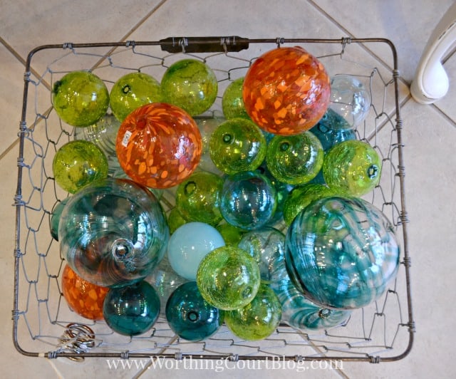 A basket filled with colorful glass fishing floats