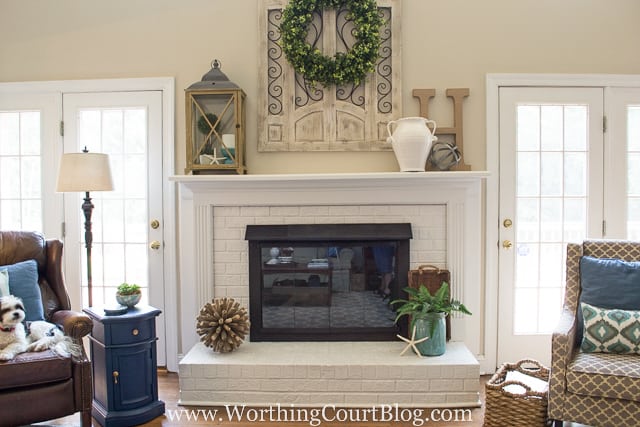 There is a soft blue table beside the fireplace in the living room.