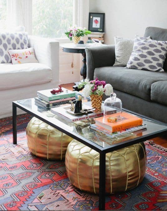 Use a coffee table that's open underneath to store small stools or poufs for extra seating