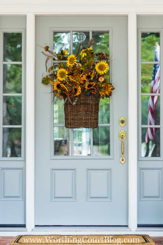 Super easy to do fall front door hanging basket filled with floral bushes