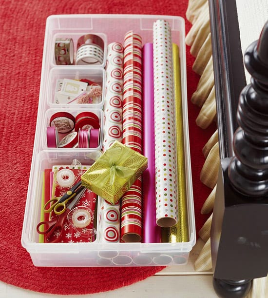 Large plastic containers with low sides are great for storing wrapping paper supplies and will slide right under a bed