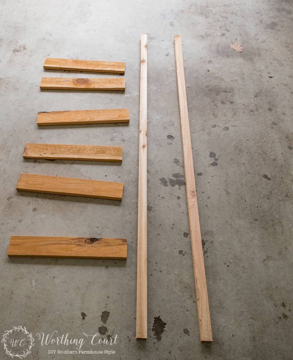 Pieces of wood laid out on the floor to make the ladder.