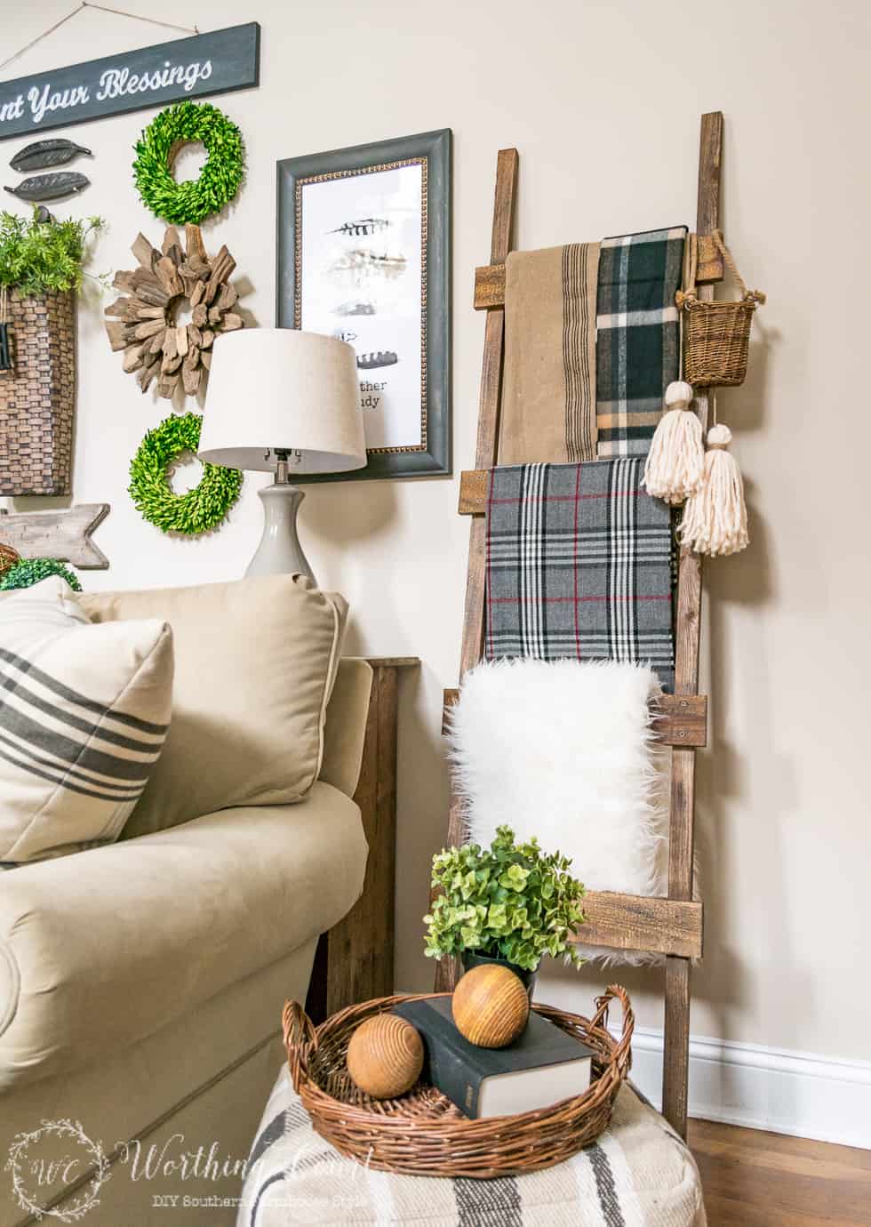 A rustic ladder with blankets on it leaning against the wall.